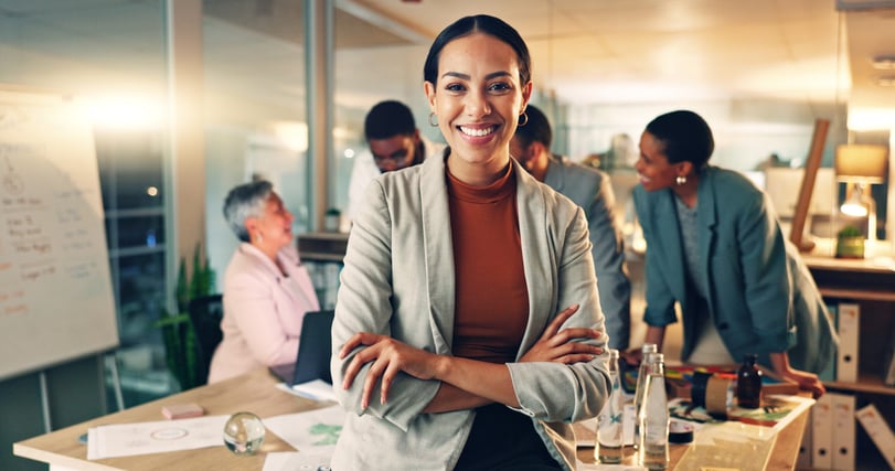 Professional standing in front of a team during a discussion about collaboration and results