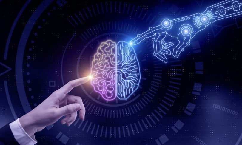 Illustratie van een menselijke hand en robotarm rond een digitaal brein als symbool voor samenwerking tussen mens en AI.