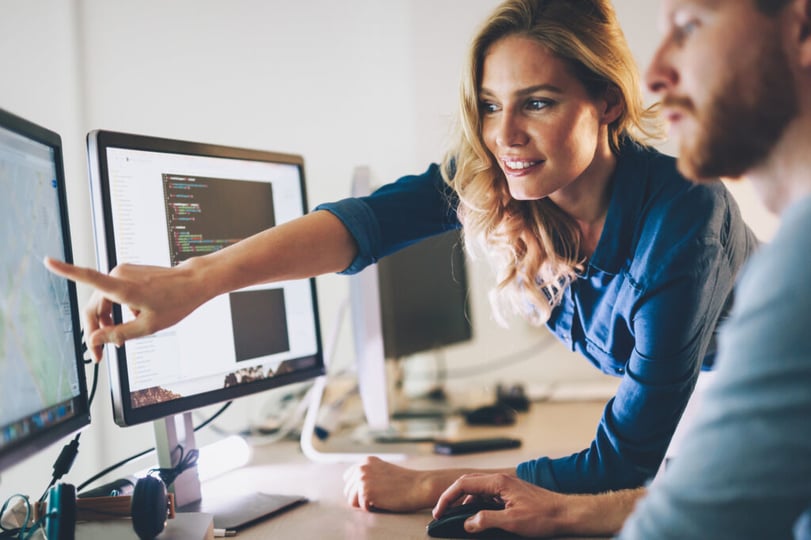 Software team members pointing to computer