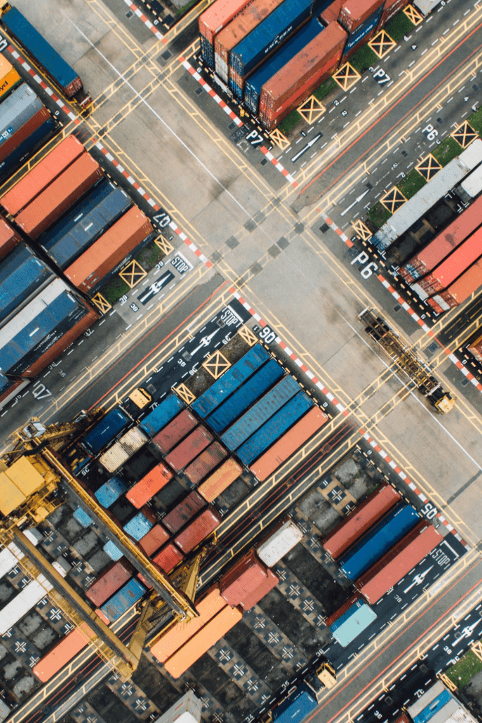 Aerial view of a container terminal with stacked shipping containers for intermodal transport, featured in the Frontliners logistics software case study by NetRom Software.