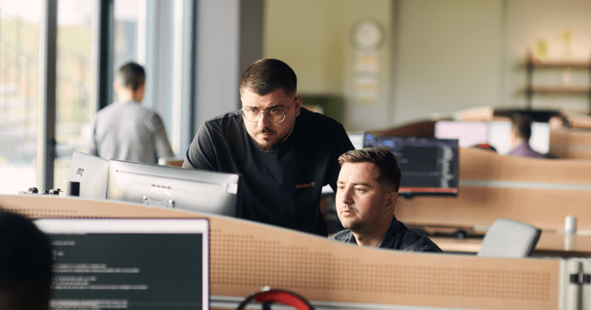 Two software developers working together on code