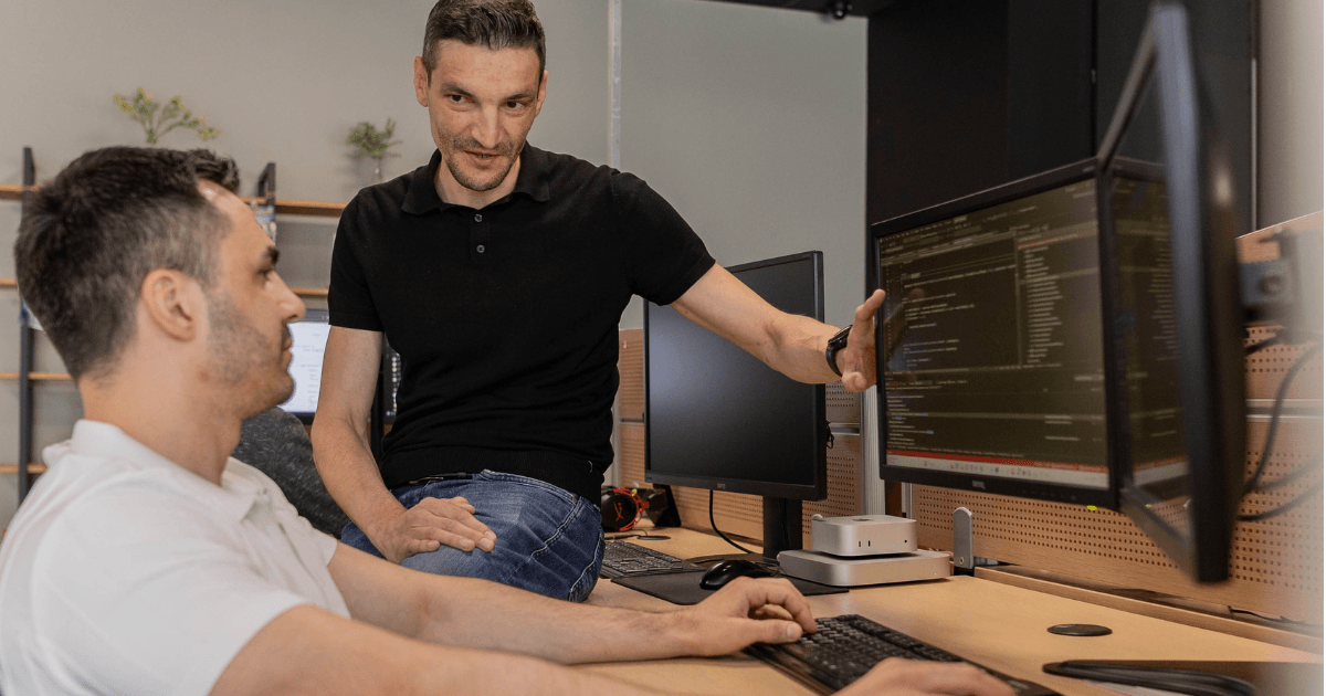 NetRom software engineers reviewing code during a quality check
