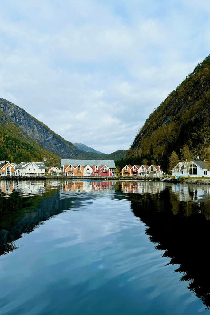 Colorful village on a fjord surrounded by green mountains in Northern Europe