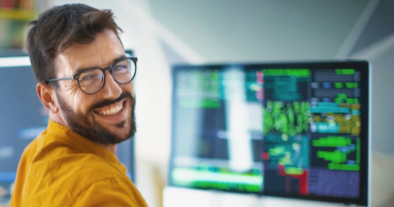 ssoftware-developer-behind-desk-smiling