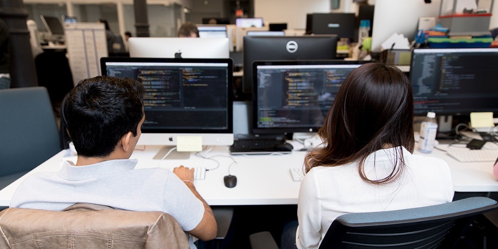 Developers discussing the AI integration into SaaS platform and its software architecture