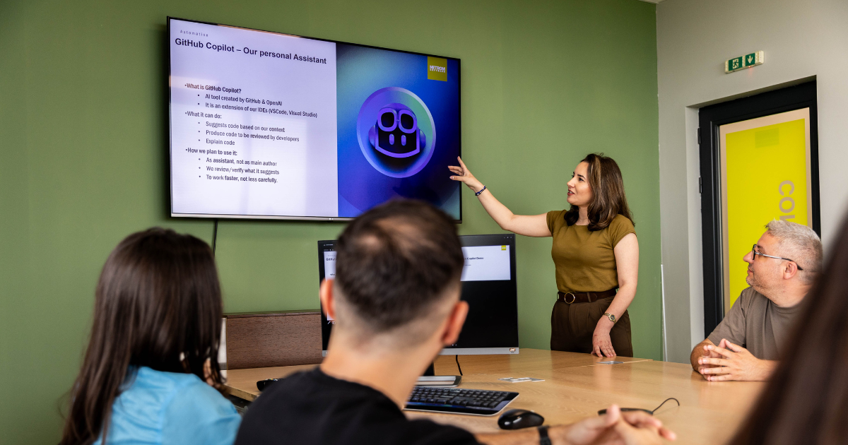 Software team during a presentation on GitHub Copilot and AI in software development