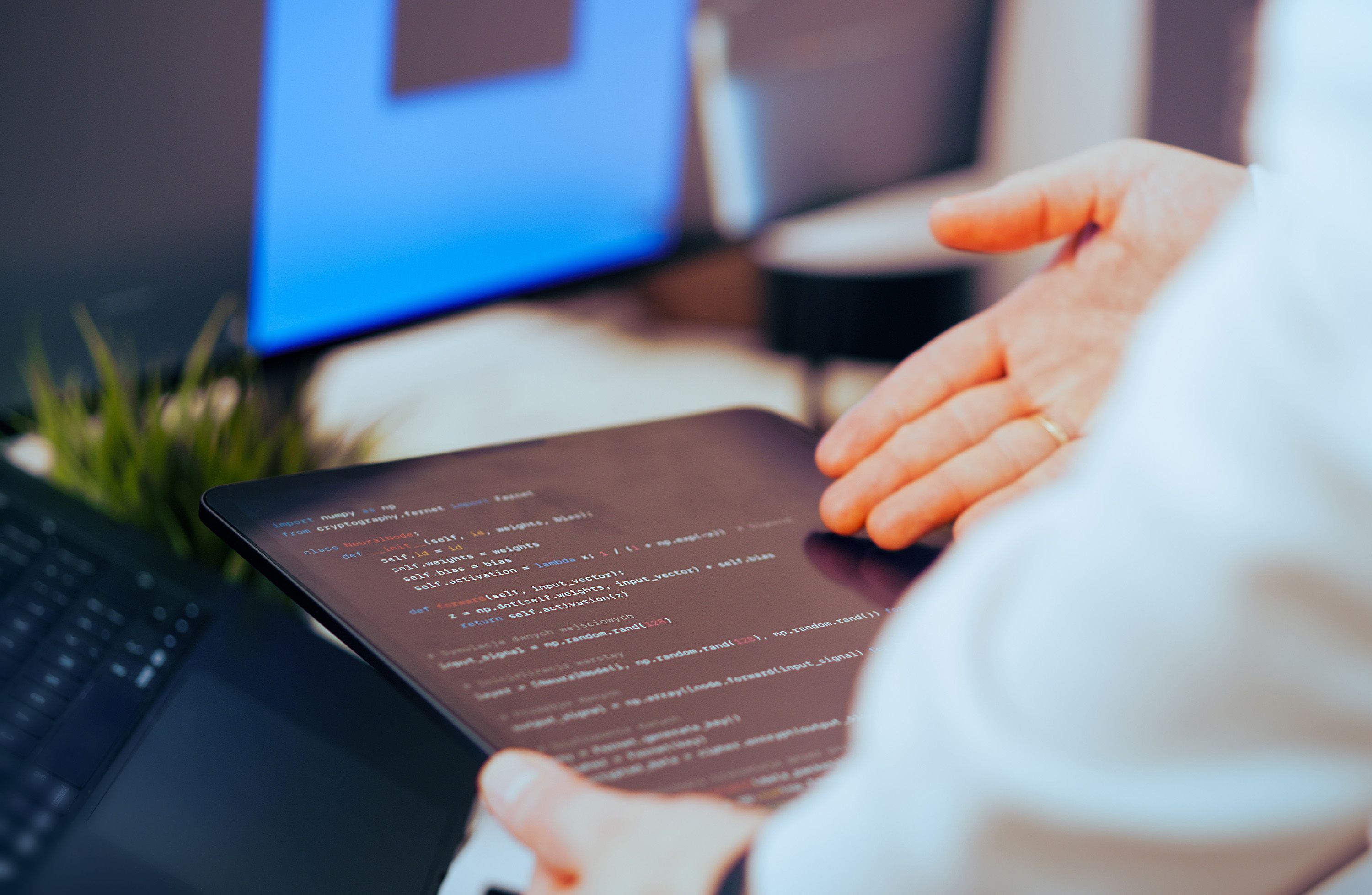 Software developer reviewing code while working on an application